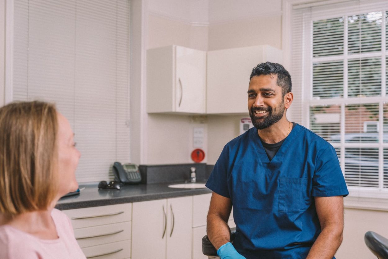Dentist at Cedar Dental Care talking with a patient in the treatment room